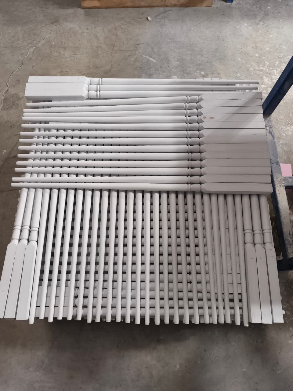 Top view of primed balusters arranged by profile