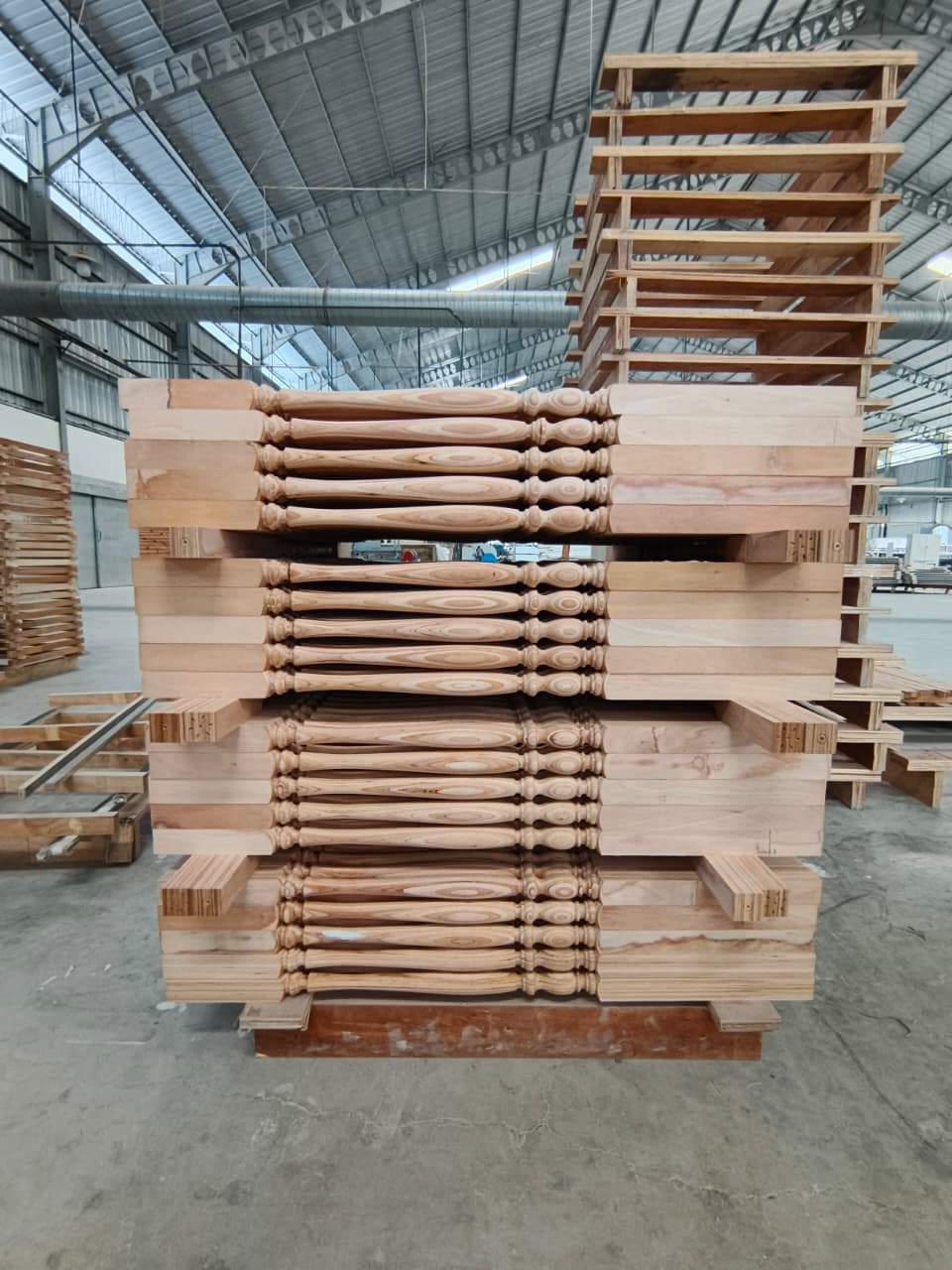 Natural wood turned balusters stacked for production